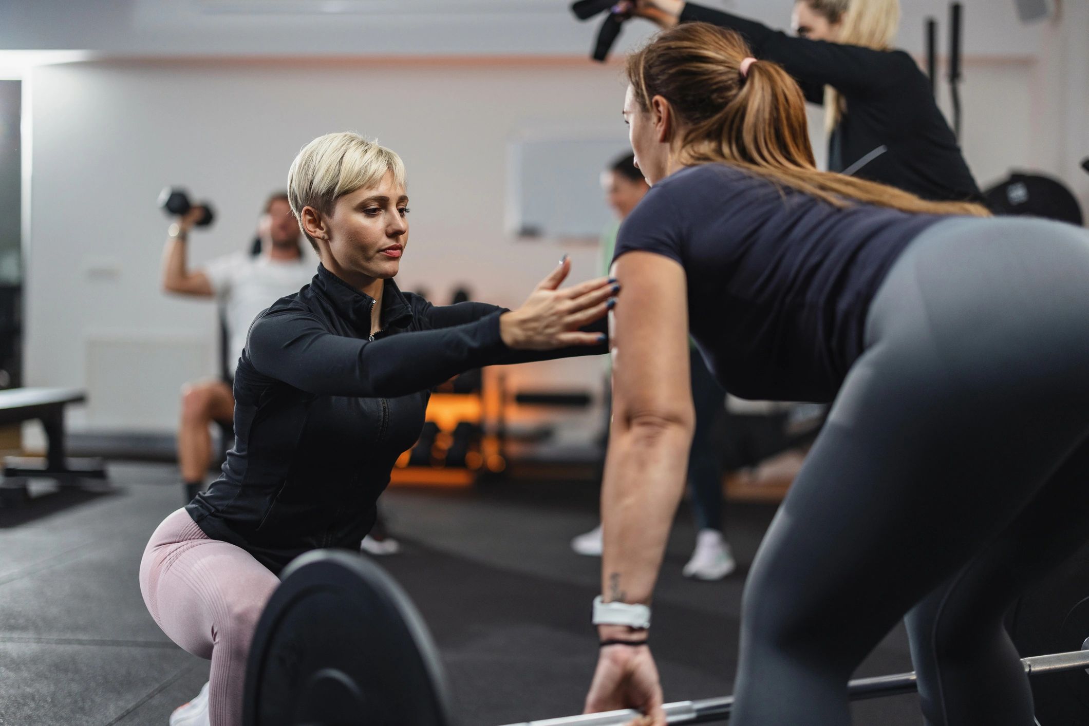 Fitness instructor coaching a client during a training session