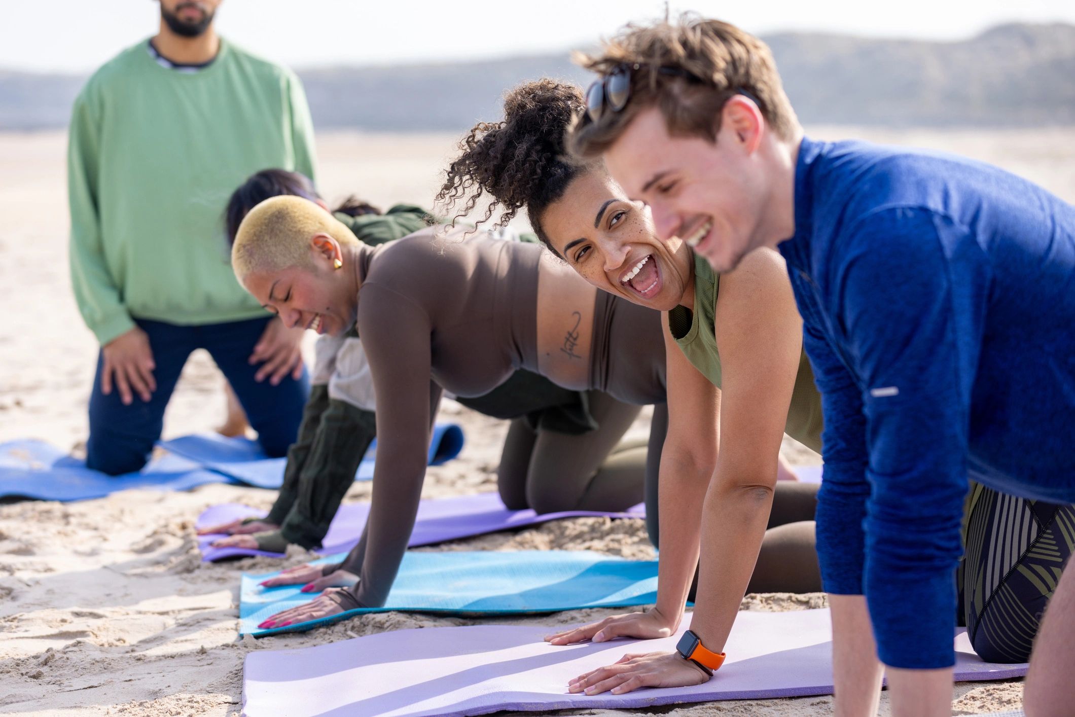 Group fitness participants exercising together outdoors
